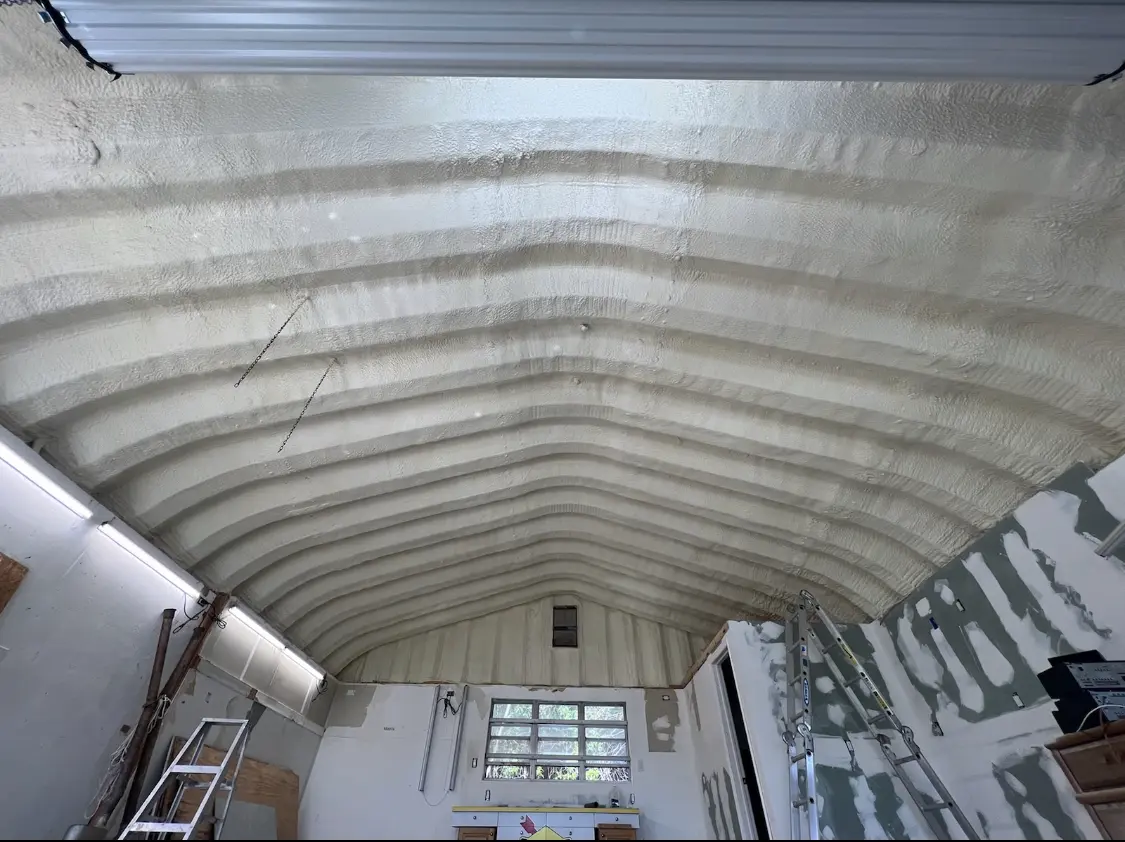 Spray polyurethane foam applied to the underside of a metal roof deck in Granville